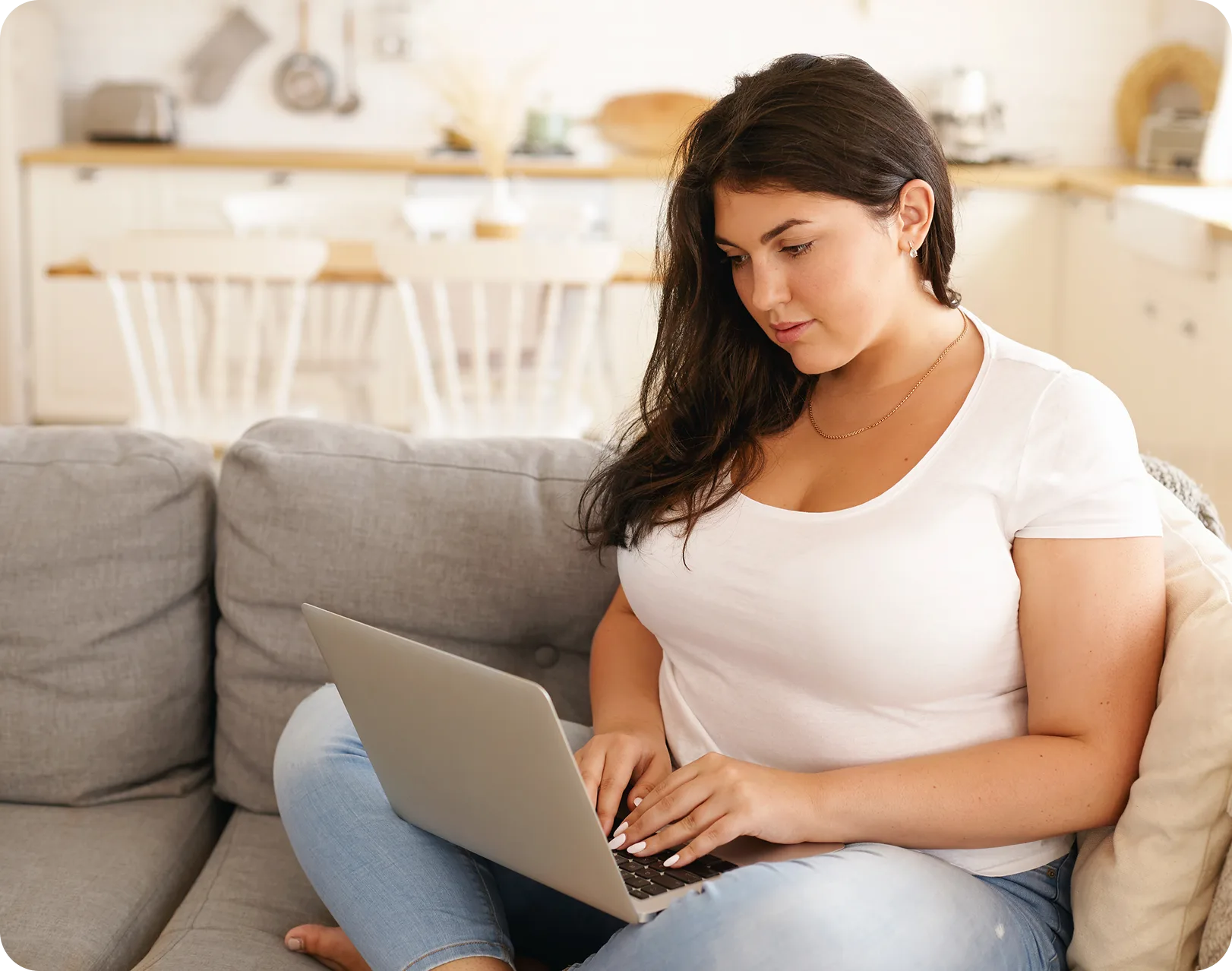 Woman completing the online assessment on her laptop at home